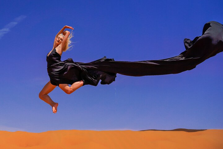 Experience the beauty of Dubai's golden dunes as you leap into adventure capturing timeless moments with a professional photoshoot against a stunning desert backdrop.